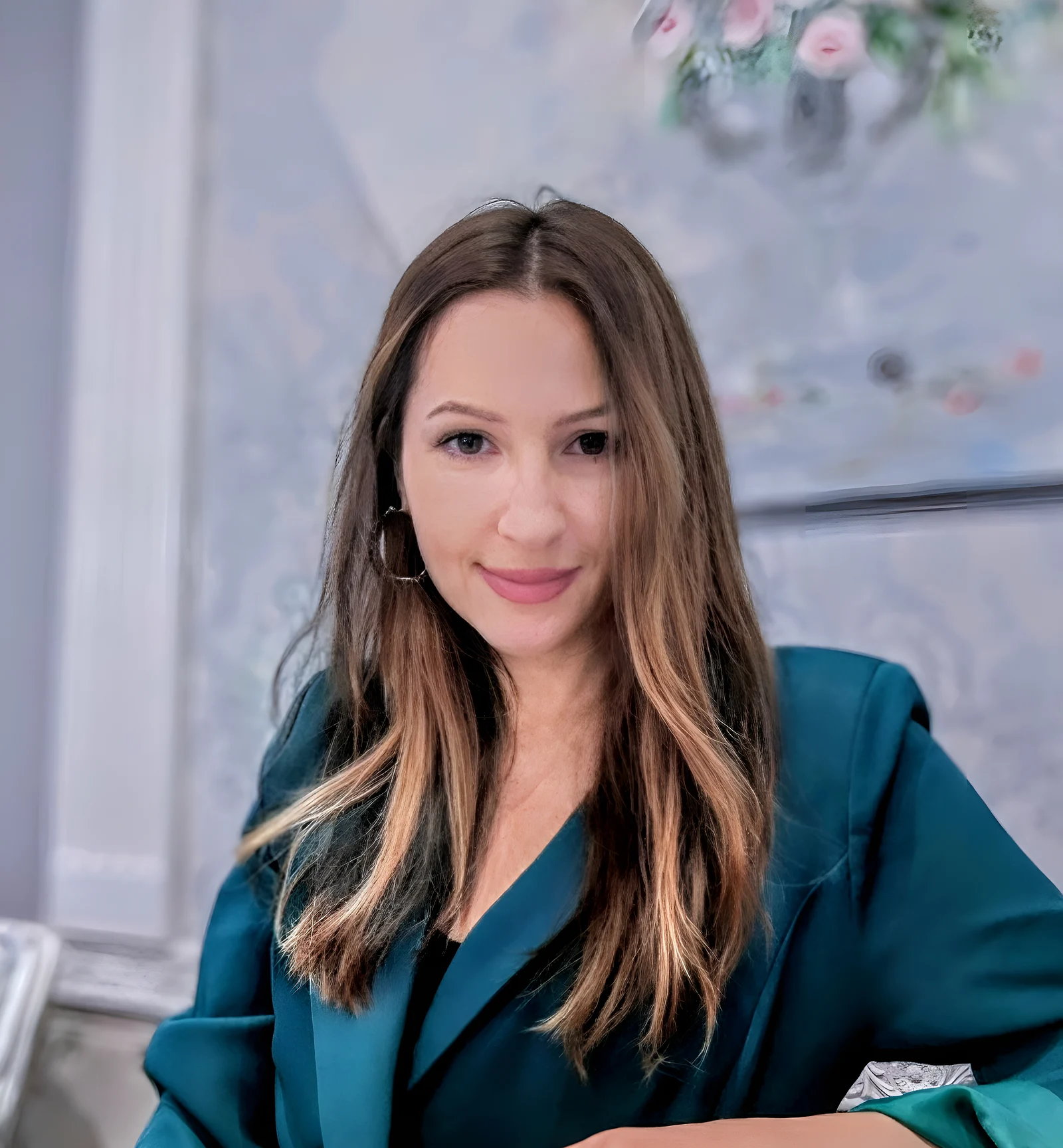 Natasha, smiling, in a green jacket